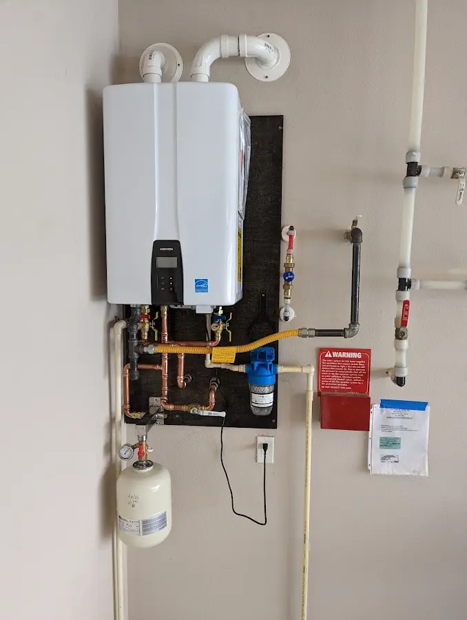 Professional plumber installing copper piping in a Solon home